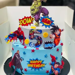 Bring the action to your party with a custom superhero cake. This two-tier Blueberry Cheesecake features favorite characters like The Hulk and Spiderman, making it a huge hit at kids' birthday parties. It's a fun and delicious way to celebrate your little hero.