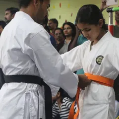 A significant moment for every student. Here, I am awarding a new belt, which is a symbol of their hard work, dedication, and progress on their karate journey.