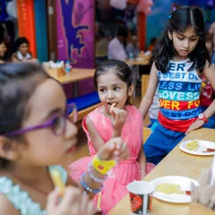 Kids taking a snack break to enjoy some fries. Our menu is designed with kid-friendly favorites to keep their energy levels up.