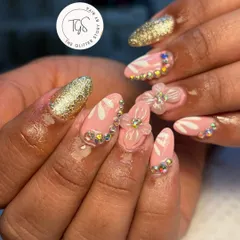 A playful and glamorous set with pink nails, hand-painted white details, 3D flowers, and a border of iridescent rhinestones for extra sparkle.
