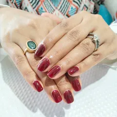 A beautiful, deep maroon color on shorter, squared-off nails, perfect for an elegant and understated look.