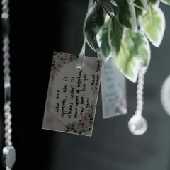 A close-up of a heartfelt note left on the wishing tree. Each blessing and piece of advice from loved ones was collected, creating a garden of memories for the couple to look back on.