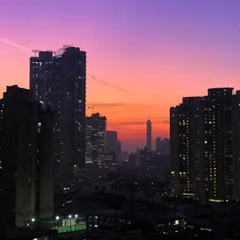A closer view of the same perfect sunset, focusing on the silhouette of the iconic Imperial Towers against the fiery sky.