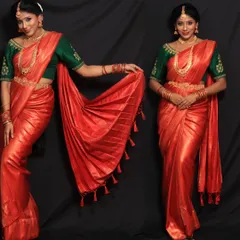 This vibrant red silk saree with a contrasting green embroidered blouse is a classic South Indian bridal look. We teach you how to create these timeless styles for your clients.
