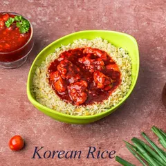 Our take on Korean Rice features fluffy fried rice topped with chicken cooked in a sweet and spicy red sauce, inspired by popular Korean flavors.