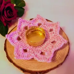Soft, sweet, and handmade with love. This baby pink, flower-shaped crochet tealight holder adds a cozy glow and a touch of charm to any corner.