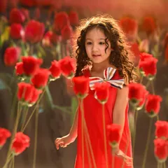 A magical moment in a field of red tulips. This entire scene was created in the studio with a combination of a projected background and real flowers in the foreground for an immersive effect.
