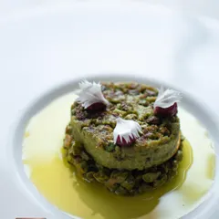 A modern take on a classic kebab. This Choliya and Edamame Galouti is served on a bed of choliya chana chaat, blending earthy flavors with a soft, melt-in-your-mouth texture.