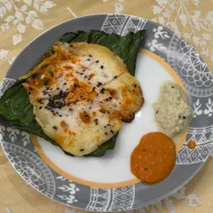 A plated shot of our popular Khada Masala Spot Idli, served with traditional coconut and tomato chutneys. A perfect bite-sized starter.