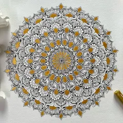 I love adding a touch of gold to my classic black and white mandalas. The metallic sheen catches the light beautifully, adding a layer of warmth and luxury to the intricate hand-drawn patterns on this A3 paper.