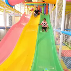 The heart of our indoor fun is this multi-level play structure, complete with colorful slides. Kids love the thrill of racing down, and our soft, padded landing areas ensure their play is always safe.