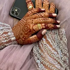 This is the beautiful result after the henna paste has been removed and the color has fully developed. The deep red-brown stain is a sign of high-quality, natural henna, perfect for any special occasion.
