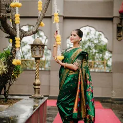 The beauty of tradition. A bride-to-be in a classic Nauvari saree, surrounded by hanging marigold flowers, creating a vibrant and culturally rich portrait.