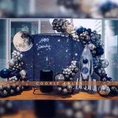 Three, two, one, blast off! We create out-of-this-world experiences like this space-themed birthday party, complete with a starry backdrop, a giant moon, a silver rocket ship, and metallic balloon details for your little astronaut.