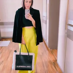 This look is all about confident, powerful styling. I paired bright neon yellow trousers with a simple black crop top and a sharp black blazer for a look that's perfect for a creative event or a stylish night out.