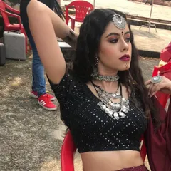 A behind-the-scenes moment from the 'Jogan' music video shoot. I created this dark boho-chic look with a sequined black choli, a deep maroon lehenga, and layers of oxidized silver jewellery, including a maang tikka, to build a mystical character.