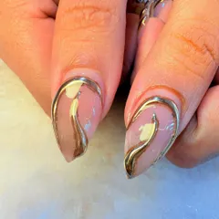 A touch of gold and a whole lot of glam. We crafted these stunning nails with a sheer nude base and flowing, three-dimensional gold chrome lines that wrap around each nail for a liquid metal effect.