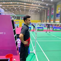 Watching my player intently from the coach's chair during a national championship match. My role is to analyze the game in real-time and provide guidance between points.