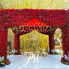 A mandap completely covered in thousands of red roses. This was a bold, romantic statement for a Muhurtham ceremony, creating an unforgettable backdrop against the venue's natural bamboo grove.