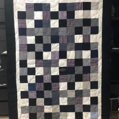 A classic checkerboard memory quilt made from a collection of men's shirts. The simple pattern allows the different fabrics and memories associated with them to take center stage.