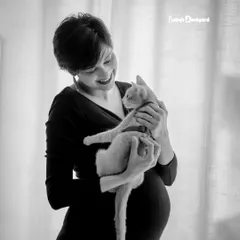 A sweet cuddle with the first baby of the house. This black and white photo captures the gentle love between an expecting mother and her cat.