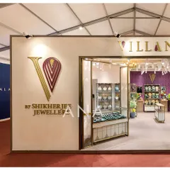 The exterior branding for the Villandi stall is subtle yet impactful, with a three-dimensional logo in gold and maroon. This detail reinforces the brand's luxury positioning before a visitor even steps inside.