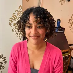 The after shot of Melina's curl transformation. I shaped her hair into a defined curly bob with bangs to frame her face.