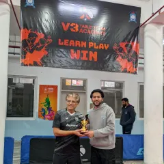 The runner-up of the Men's Singles event receiving his trophy. The corporate tournament saw participation from 50 players, making for a highly competitive field.