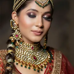 A close-up with the bride's eyes closed, showcasing the dramatic dark smokey eye, a key element of this majestic look.