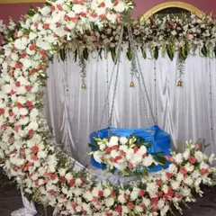 A closer look at the detailed flower work on our crescent moon cradle setup. We use a dense arrangement of fresh flowers to create a lush and beautiful frame for the baby's first big event.