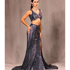 A full view of our shimmering co-ord set. The high-slit skirt and detailed crop top are designed to create a powerful silhouette, perfect for any celebration where you want to feel confident and bold.