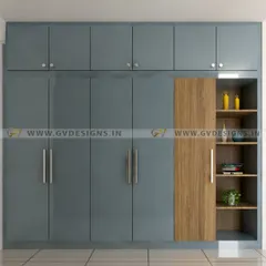 This floor-to-ceiling swing wardrobe combines a captivating blue hue with warm wooden accents on the side-open storage unit. The design offers generous storage capacity with a harmonious blend of colors and textures.
