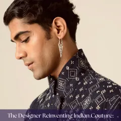 A portrait of a male model styled in a contemporary bandhgala by designer Divyam Mehta. The look reinvents Indian couture with modern sensibilities, featuring subtle details and a sharp silhouette.