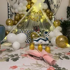For a truly personal celebration, I designed this romantic birthday surprise in a client's home in Govandi. A beautiful canopy tent over the bed, adorned with fairy lights and a cascade of white and gold balloons, created a cozy and magical space for a private and unforgettable evening.