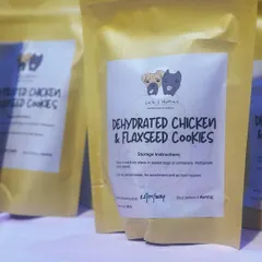 Our Dehydrated Chicken & Flaxseed Cookies, ready to go. Each pouch is packed with protein and healthy fats, featuring our clear labeling so you know exactly what you're feeding your best friend.