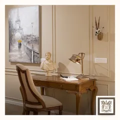 This hand-painted piece depicting a romantic Parisian street scene adds a touch of vintage charm to a classic study. The soft colors and gentle atmosphere of the painting create a serene and inspiring workspace.