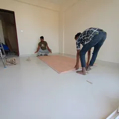 Precision is key in our work. Here, our carpenters are laying down plywood flooring sheets, ensuring a perfect foundation for the wooden flooring that will be installed in this bedroom.