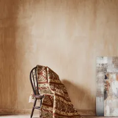 A simple, elegant still life focusing on the texture and pattern of a rug. The monochromatic color palette and soft lighting create a calm, artistic mood for this home fashion brand.