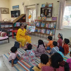 A closer view of our story session, showing the children's rapt attention. The background filled with books highlights the literary environment we nurture.