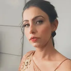 A soft and sophisticated look for a sister attending a mehndi function. The makeup is understated, with a focus on flawless skin and gently defined eyes, paired with a simple pulled-back hairstyle.