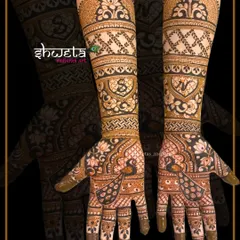 Personalize your mehendi with initials. This traditional design incorporates the couple's initials within heart shapes, surrounded by peacock and lotus patterns.