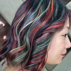 A creative multi-tonal look with streaks of red, green, and blonde. This is for the client who isn't afraid to play with color and wants a truly artistic hairstyle.