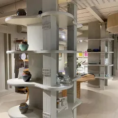 We designed these custom, multi-tiered shelving units to act as functional sculptures within the open-plan space. Their organic, flowing shelves provide a unique way to display smaller decor items and pottery, breaking up the vertical space and adding visual interest.