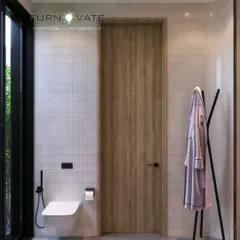 A minimalist bathroom with a clean and natural aesthetic. The design features a simple wooden door, a wall-mounted toilet, and white grid tiles for a bright and airy feel.