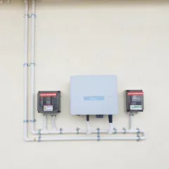 A perfect example of our commitment to neat and clean work. This wall-mounted inverter and distribution box setup features organized wiring, ensuring safety and a professional aesthetic.