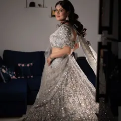 A full-length view showing how the side-swept waves balance the heavily embellished lehenga. This is a perfect look for a bride who wants to shine at her reception.