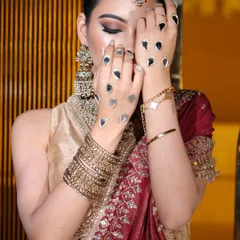 A close-up on the unique hand detailing and the sharp, winged eyeliner. This look is a perfect blend of traditional elements and modern makeup artistry.