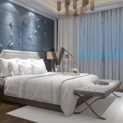 An example of luxury meeting simplicity in bedroom design. A deep blue feature wall with delicate butterfly accents creates a whimsical yet sophisticated focal point. The elegant chandelier and tufted bench add a timeless, classic touch.