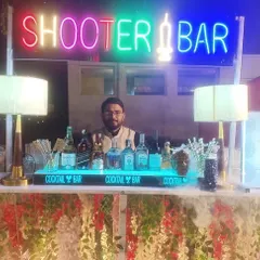 A dedicated 'Shooter Bar' setup with a colorful neon sign, offering a wide array of fun and creative shots to keep the party energy high.
