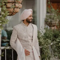 A candid shot of the groom, Gurpreet, looking relaxed and happy on his wedding day.